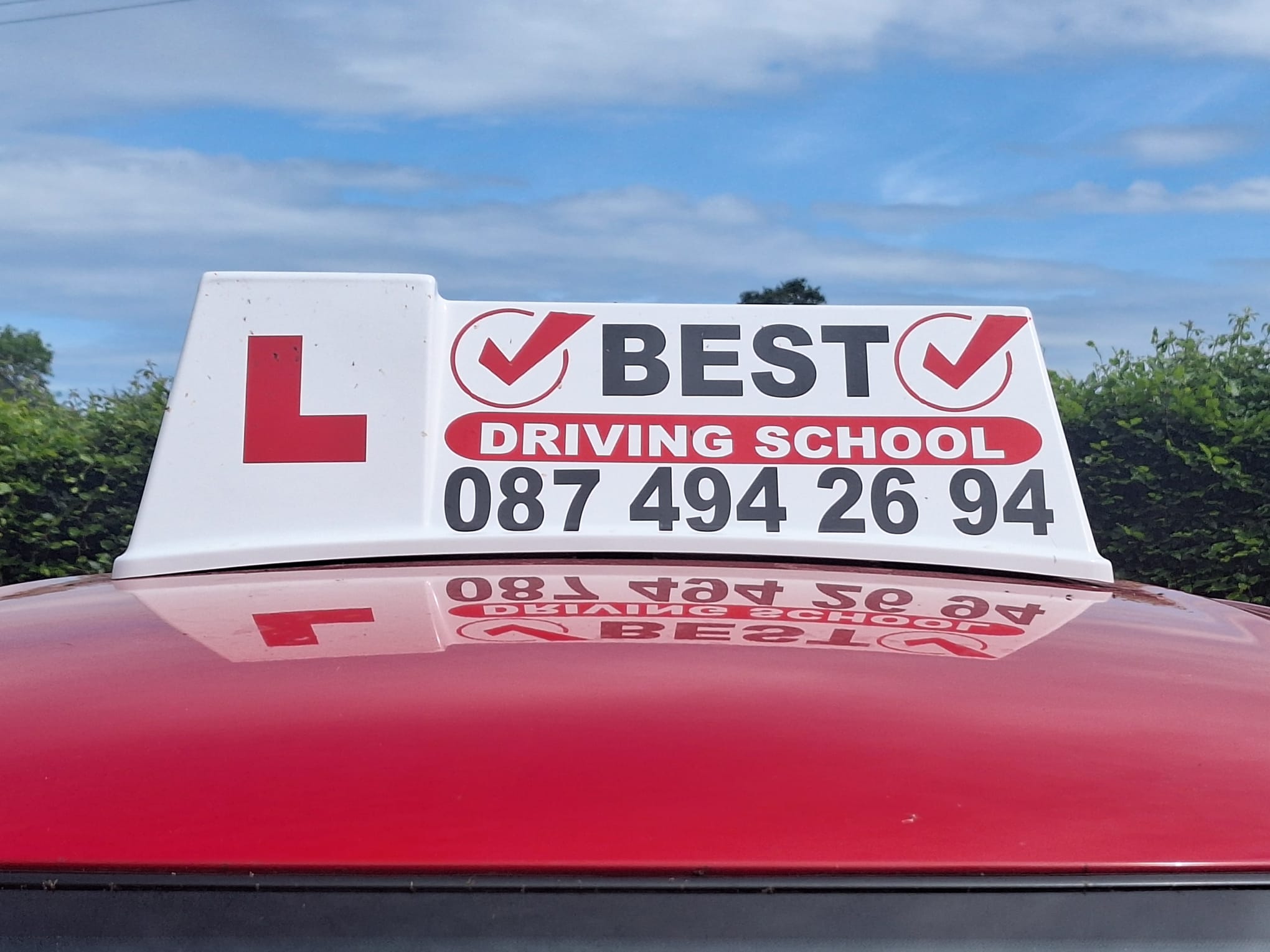 image of a sign on top of a driving instructors car